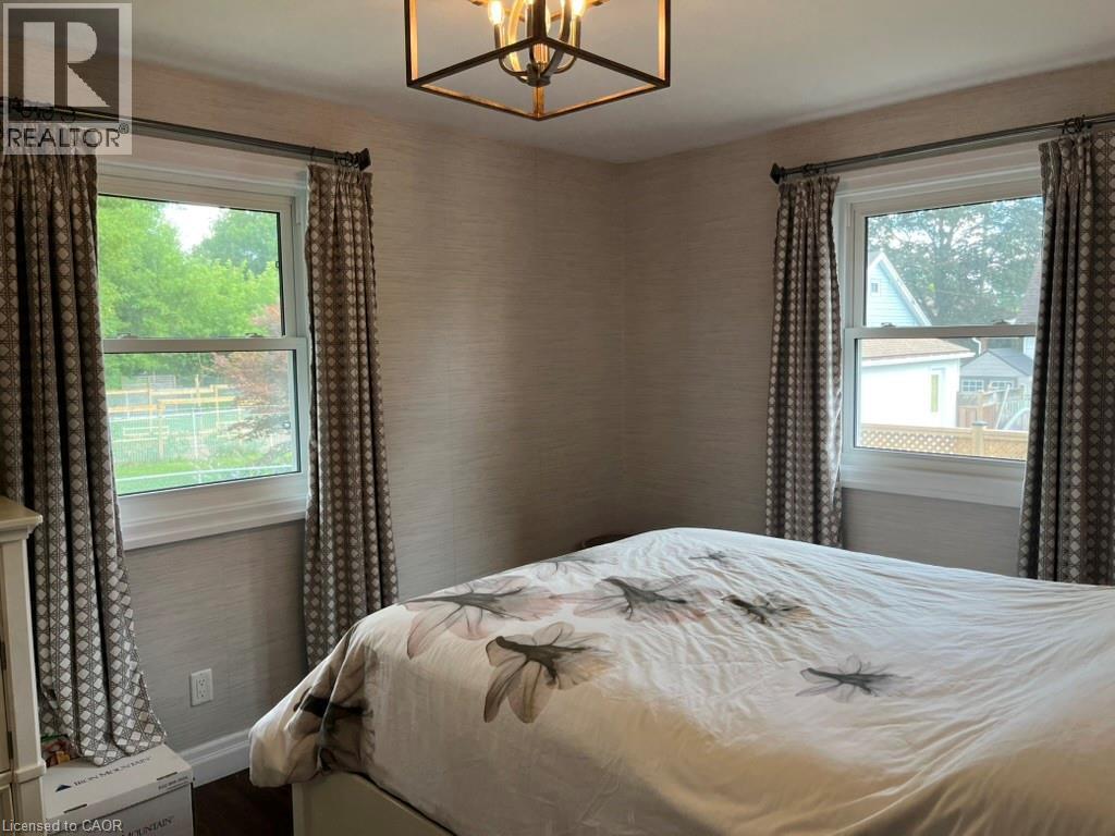 Bedroom featuring a chandelier and baseboards - 235 Fearnwood Street, Cambridge, ON - Indoor Photo Showing Bedroom