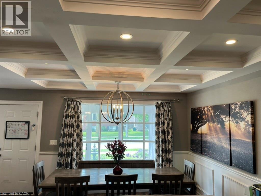 Dining room with beam ceiling, a chandelier, coffered ceiling, and a decorative wall - 235 Fearnwood Street, Cambridge, ON - Indoor Photo Showing Other Room