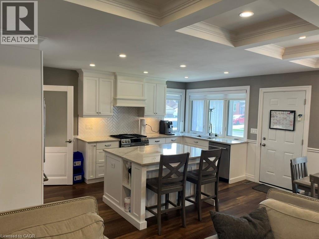 Kitchen with coffered ceiling, light stone countertops, white cabinetry, beamed ceiling, and backsplash - 235 Fearnwood Street, Cambridge, ON - Indoor Photo Showing Kitchen With Upgraded Kitchen