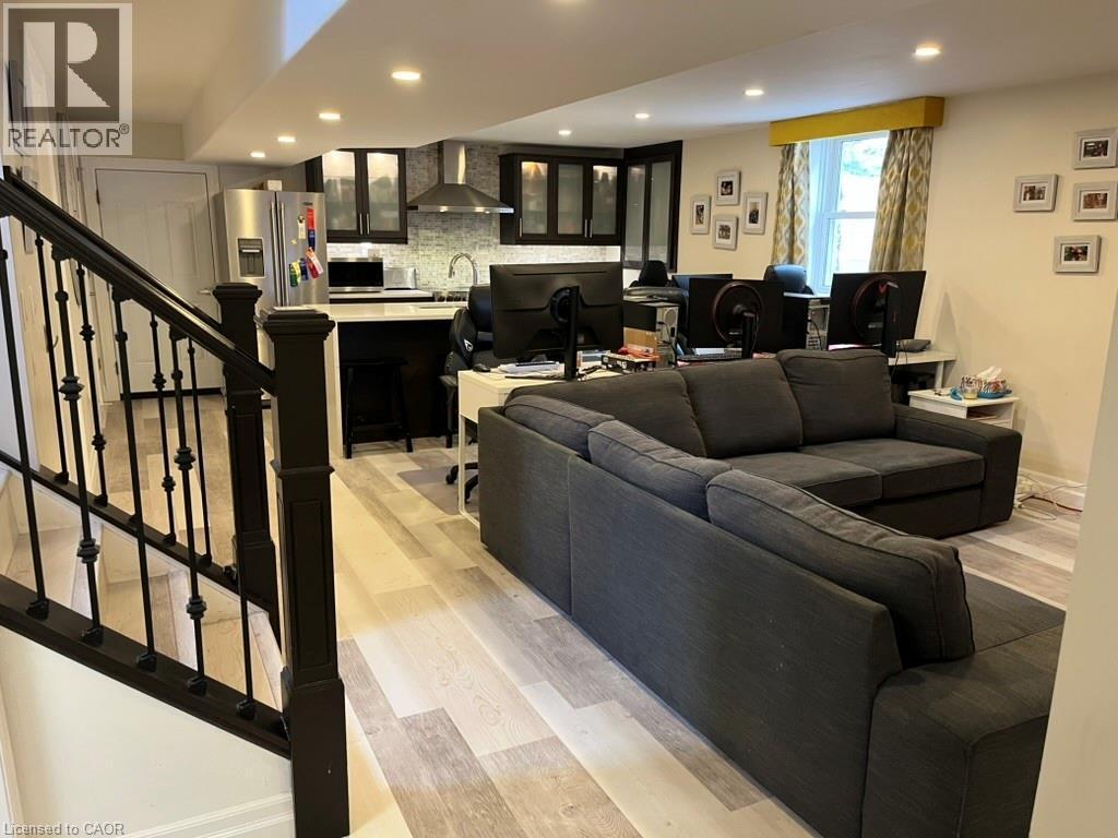 Living room featuring light wood-style floors, recessed lighting, and stairway - 235 Fearnwood Street, Cambridge, ON - Indoor