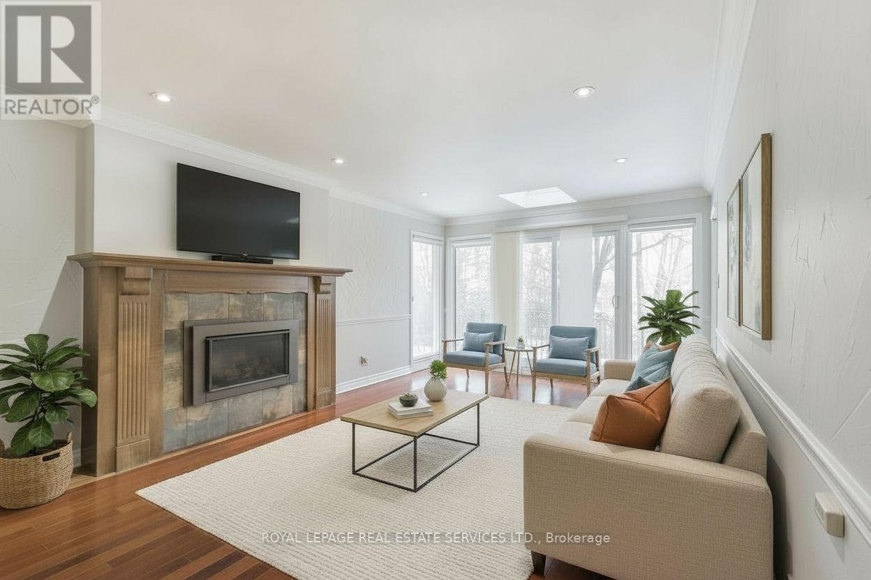 This photo has been virtually staged - 4261 Bridlepath Trail, Mississauga, ON - Indoor Photo Showing Living Room With Fireplace