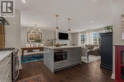 Kitchen features plenty of storage in island with lots of workspace, microwave is handy and yet nicely tucked away. -