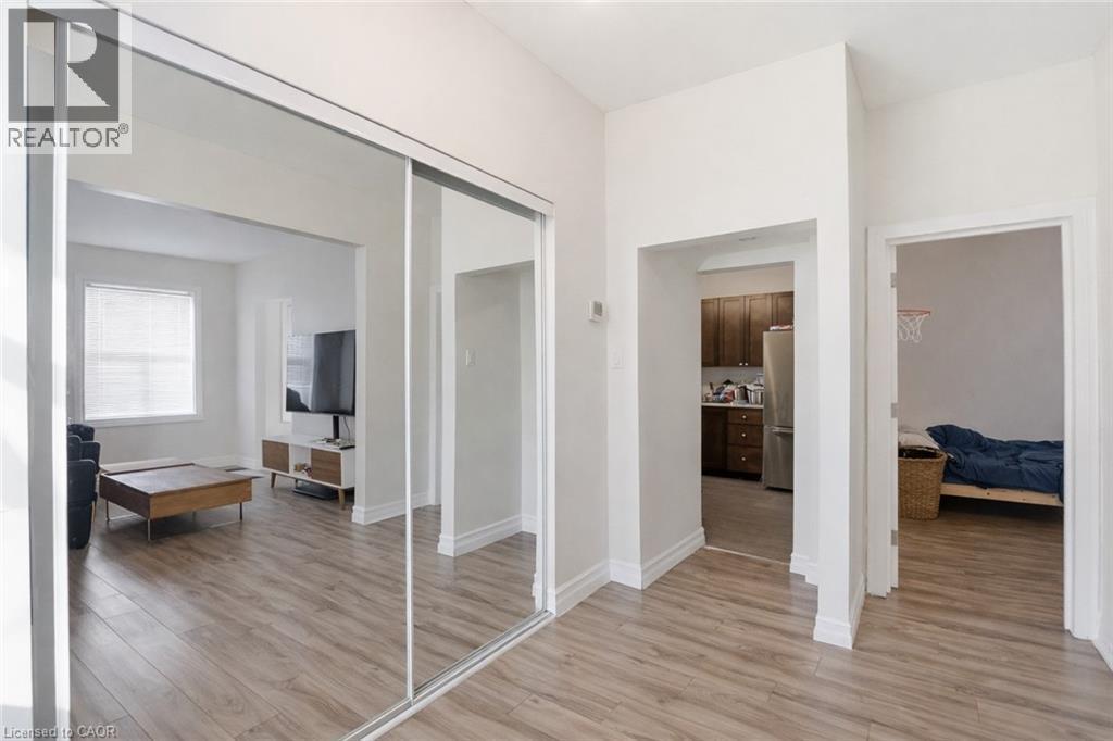 Hall featuring light wood finished floors and baseboards - 260 Prospect Street S, Hamilton, ON - Indoor Photo Showing Other Room