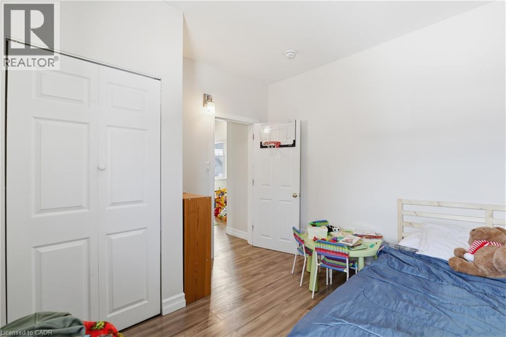 Bedroom with light wood finished floors and a closet - 260 Prospect Street S, Hamilton, ON - Indoor Photo Showing Bedroom