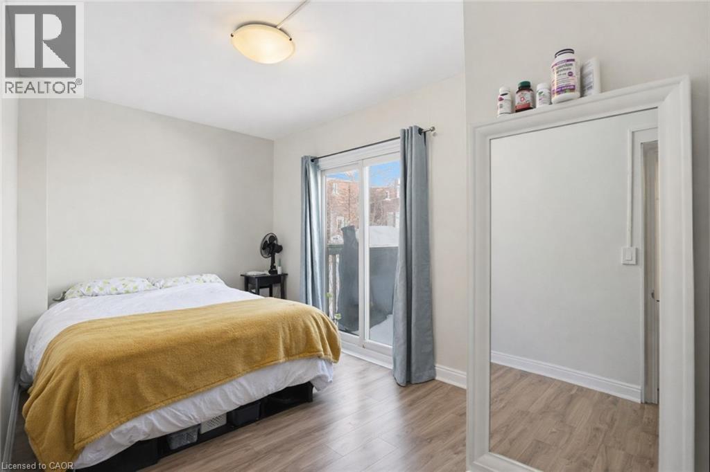 Bedroom featuring light wood finished floors and baseboards - 260 Prospect Street S, Hamilton, ON - Indoor Photo Showing Bedroom