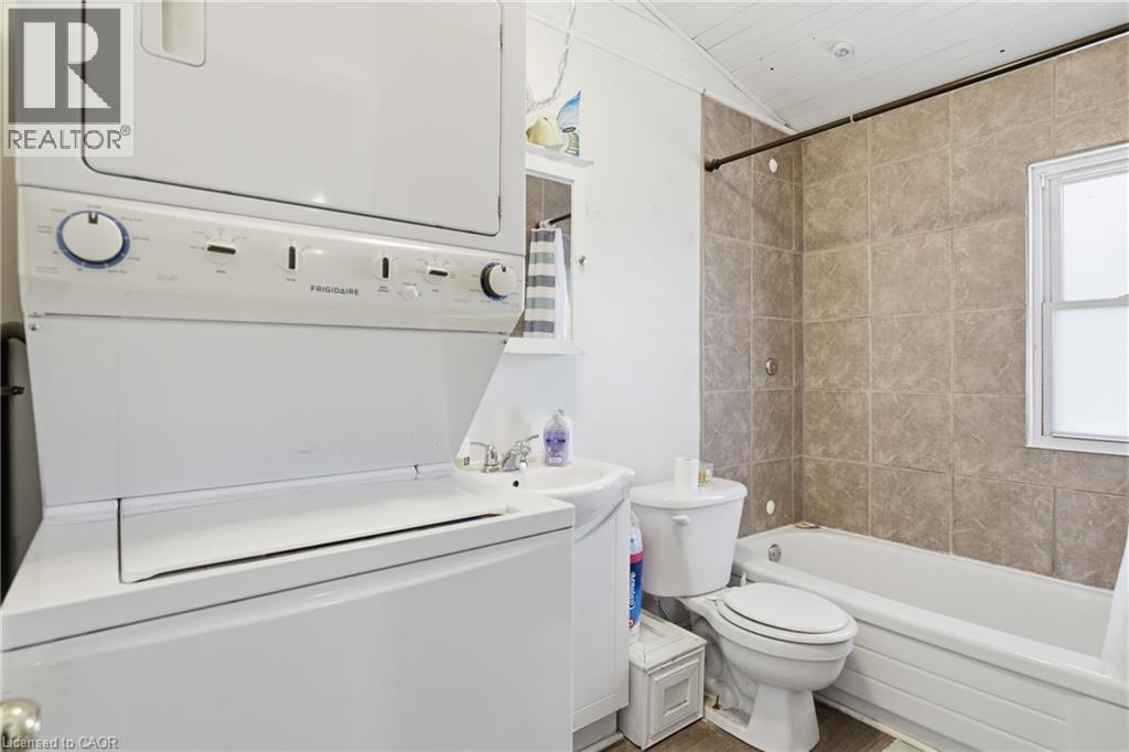 Bathroom with shower / bath combination, vanity, and stacked washer and dryer - 260 Prospect Street S, Hamilton, ON - Indoor Photo Showing Laundry Room