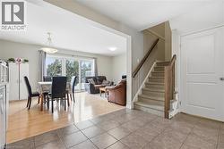 Dining space featuring light tile patterned floors and stairway -