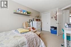 Bedroom with light carpet, a closet, and a textured ceiling -
