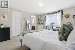 Bedroom featuring light colored carpet and baseboards -