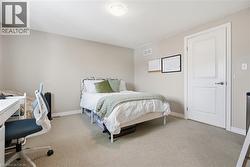 Bedroom with a desk and carpet flooring -