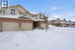 View of front of house featuring board and batten siding, a residential view, brick siding, and an attached garage -