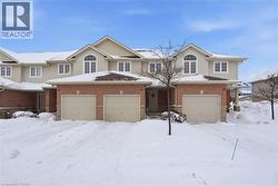 View of front of property featuring board and batten siding, brick siding, and an attached garage -