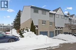 Traditional-style home featuring brick siding and an attached garage -
