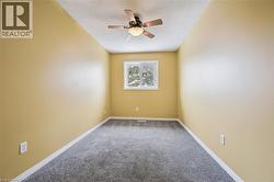 Spare room with carpet, a ceiling fan, and a textured ceiling -