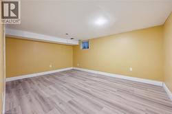 Spare room with baseboards and light wood finished floors -