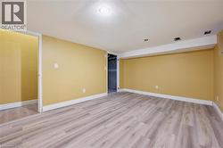 Unfurnished room with light wood-style flooring and baseboards -