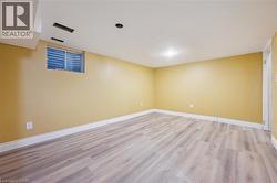 Empty room with light wood-style flooring and baseboards -