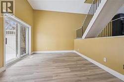 Spare room featuring light wood-style floors and baseboards -