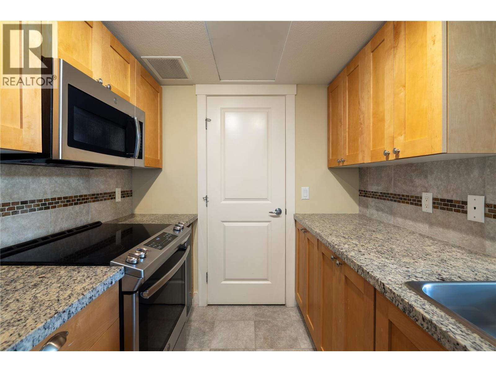 In suite laundry just off the kitchen. - 4205 Gellatly Road Unit# 416, West Kelowna, BC - Indoor Photo Showing Kitchen