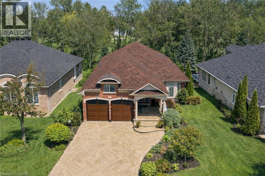 View of front of property featuring a front lawn, driveway, brick siding, and covered porch - 17 Mcnutt Street, Brampton, ON - Outdoor