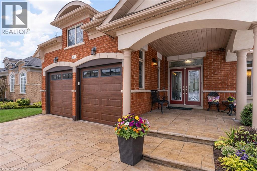 View of front facade featuring brick siding, french doors, and driveway - 17 Mcnutt Street, Brampton, ON - Outdoor