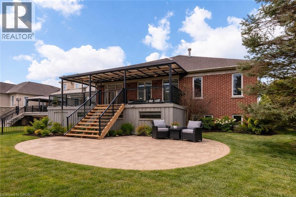 Back of house featuring a patio, a lawn, brick siding, and an outdoor living space - 17 Mcnutt Street, Brampton, ON - Outdoor