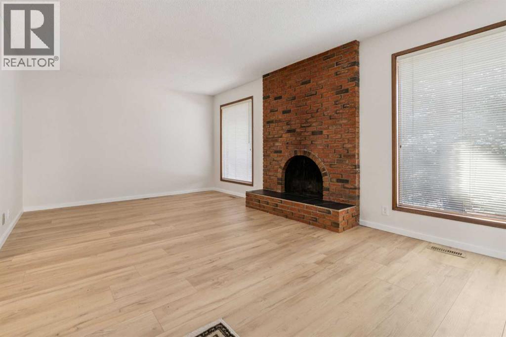 91 Edgehill Drive Nw, Calgary, AB - Indoor Photo Showing Living Room With Fireplace