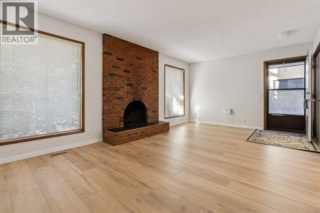 91 Edgehill Drive Nw, Calgary, AB - Indoor Photo Showing Living Room With Fireplace