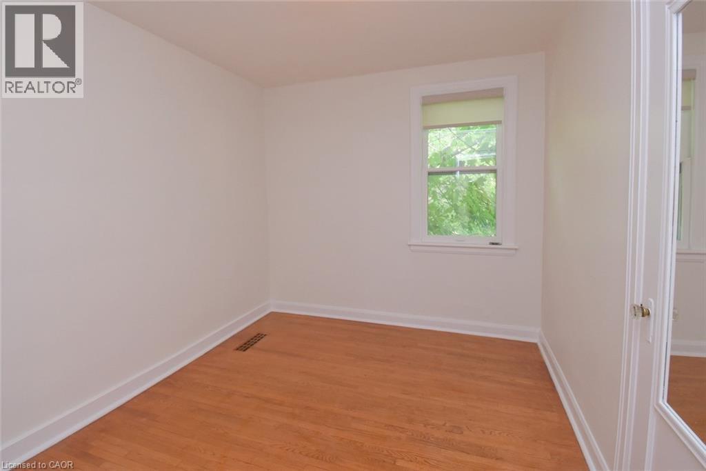 Empty room featuring light wood-style floors and baseboards - 136 Glen Road, Hamilton, ON - Indoor Photo Showing Other Room