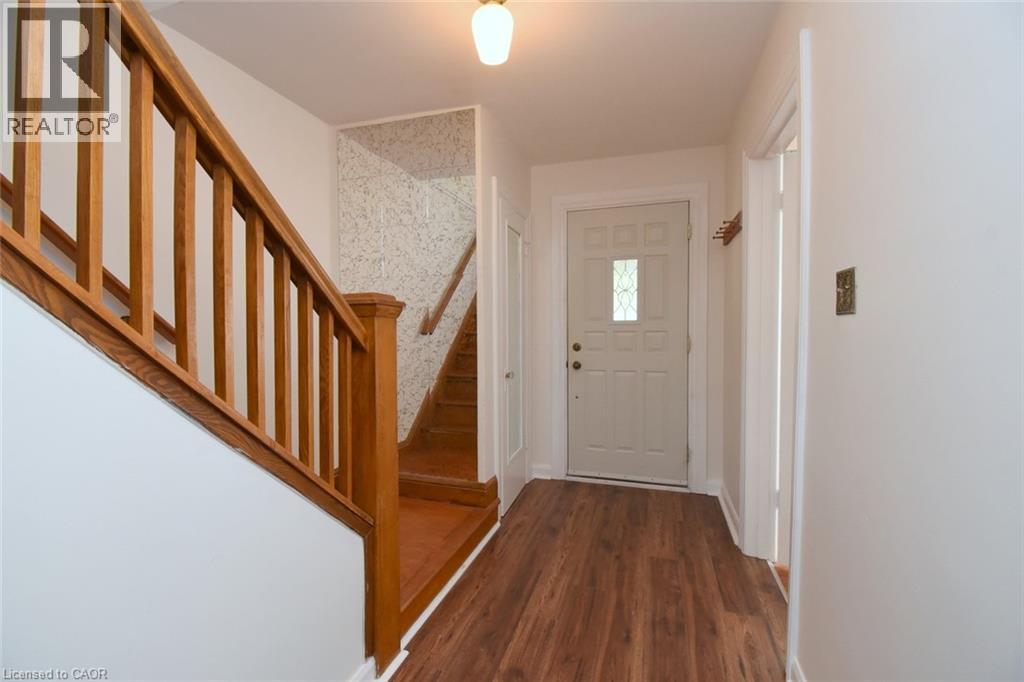 Foyer featuring stairs and dark wood-type flooring - 136 Glen Road, Hamilton, ON - Indoor Photo Showing Other Room