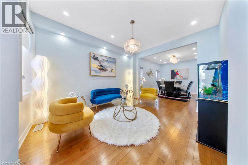 Living area with wood-type flooring and suspended lighting - 59 Greti Drive, Hamilton, ON - Indoor Photo Showing Living Room