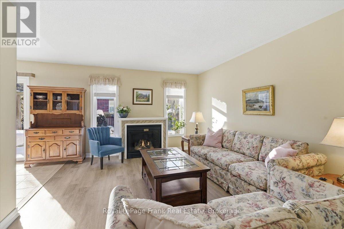Two Bright south Facing Windows Flank Fireplace - 25 Apple Tree Crescent, Uxbridge, ON - Indoor Photo Showing Living Room With Fireplace