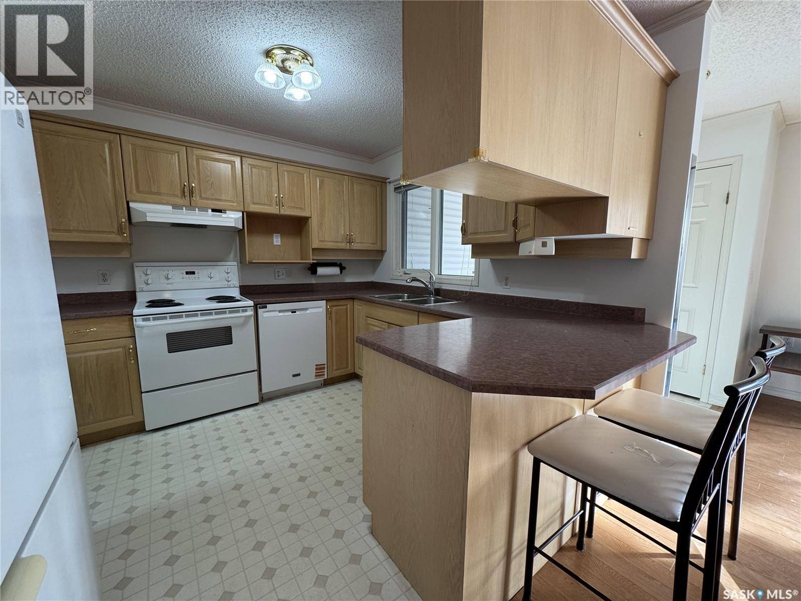 105 111 2Nd Avenue E, Rosetown, SK - Indoor Photo Showing Kitchen With Double Sink