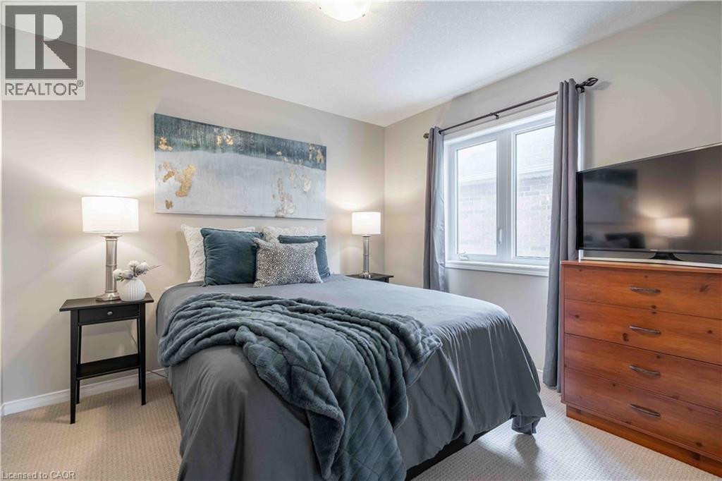 Bedroom featuring brand new light colored carpet and large window. - 115 Larry Crescent, Caledonia, ON - Indoor Photo Showing Bedroom