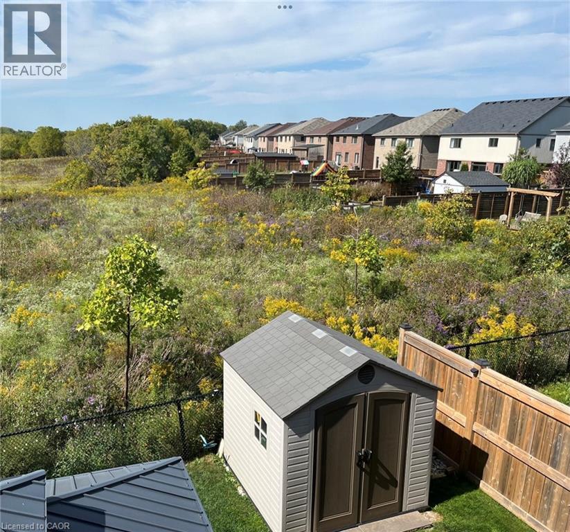 Shows the beauty of the greenspace and planted trees beyond the fence area. - 115 Larry Crescent, Caledonia, ON - Outdoor