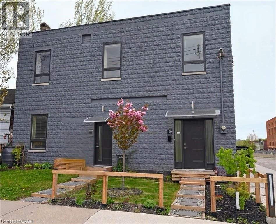 Modern facade featuring a textured block exterior and contemporary dark-framed windows - 86 Birge Street, Hamilton, ON - Outdoor