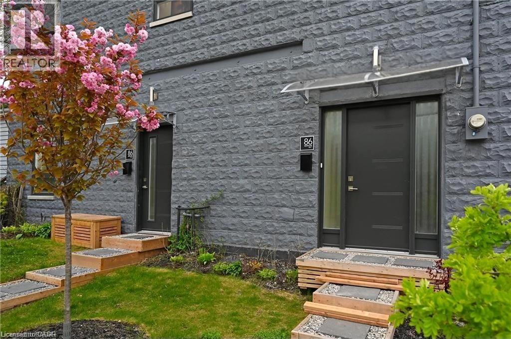 Contemporary facade featuring dark gray textured block siding - 86 Birge Street, Hamilton, ON - Outdoor