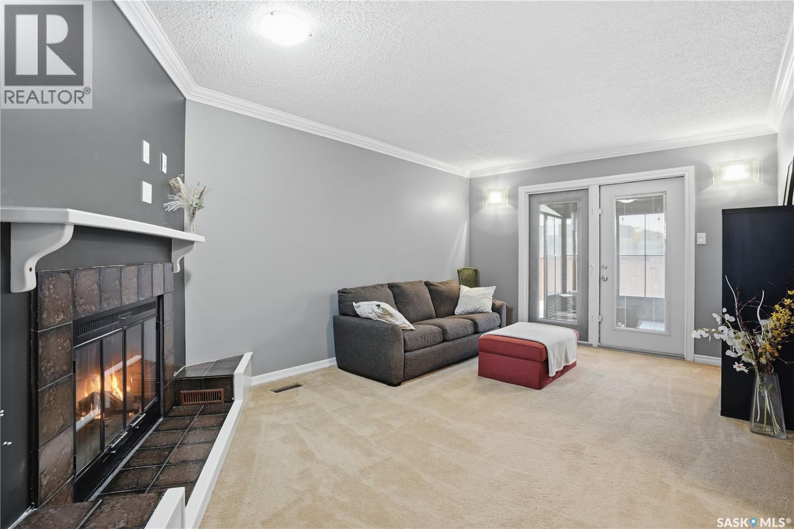 83 Carter Crescent, Regina, SK - Indoor Photo Showing Living Room With Fireplace