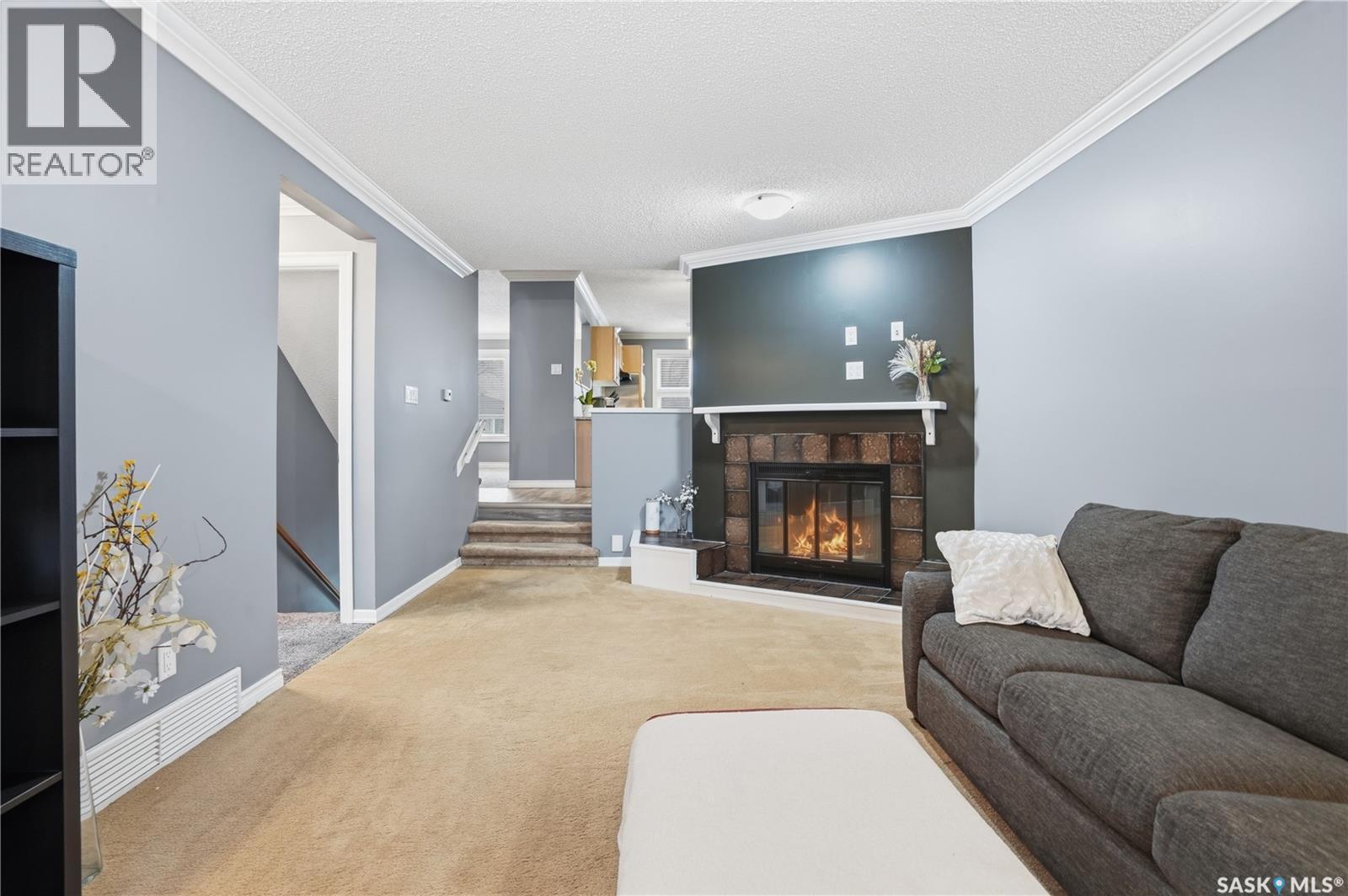 83 Carter Crescent, Regina, SK - Indoor Photo Showing Living Room With Fireplace