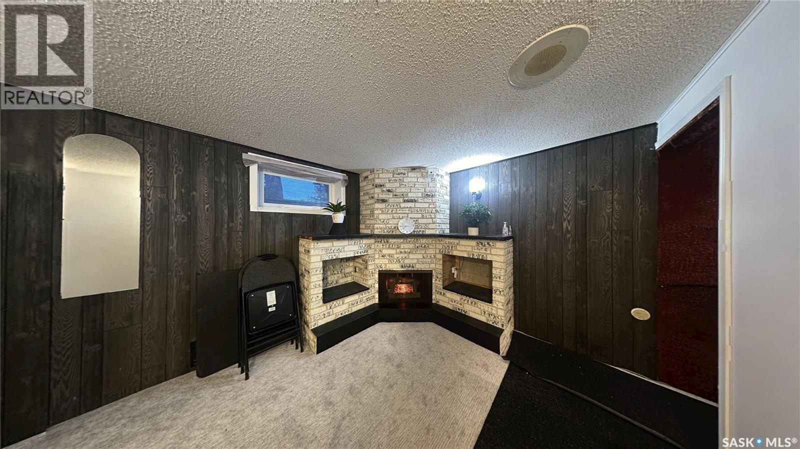 41 Cartier Crescent, Saskatoon, SK - Indoor Photo Showing Other Room With Fireplace