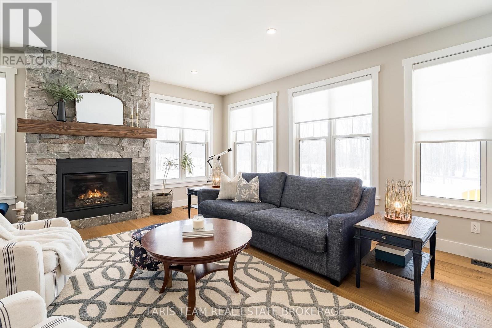 1555 Baseline Road S, Tiny, ON - Indoor Photo Showing Living Room With Fireplace
