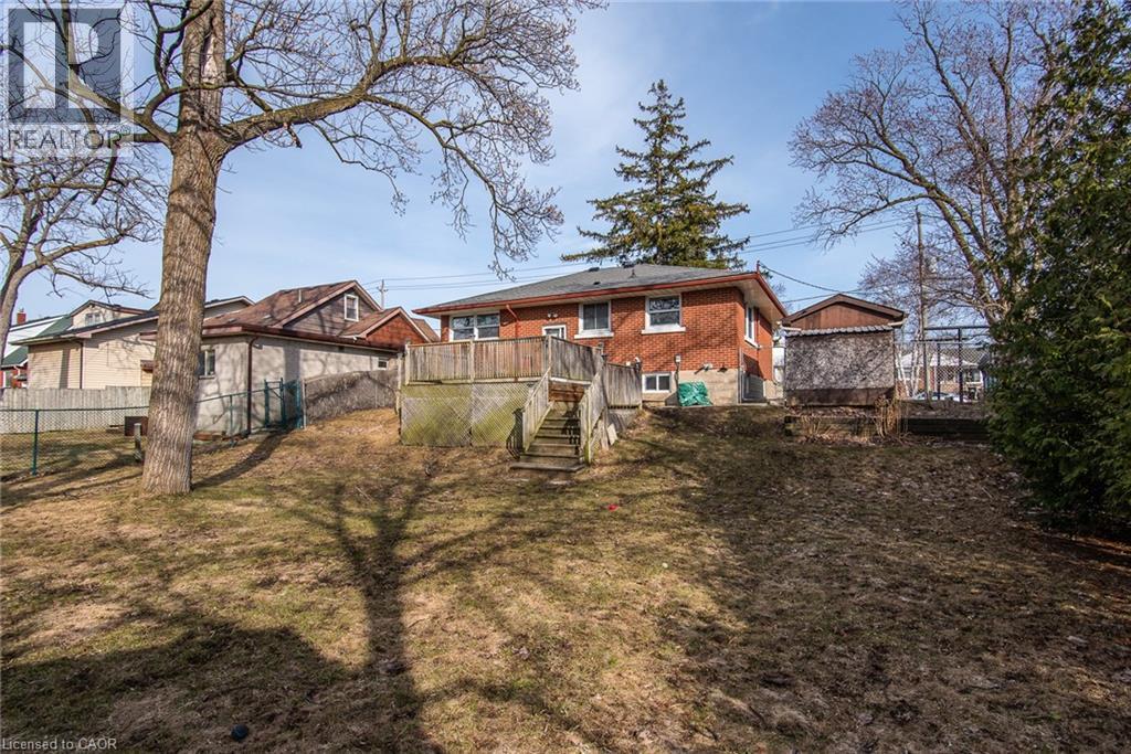Back of property featuring a deck and brick siding - 120 Fourth Avenue, Kitchener, ON