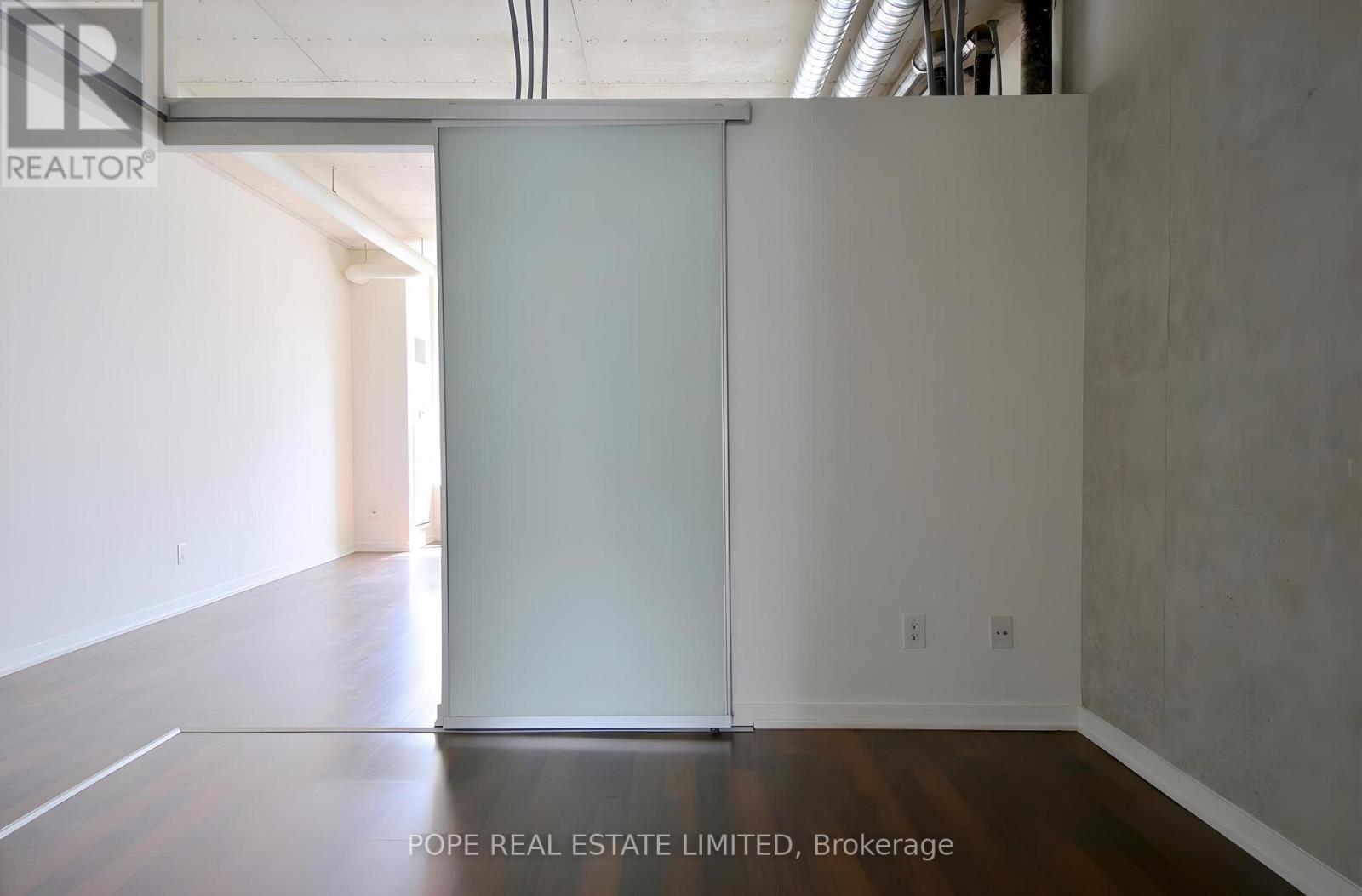 Bedroom 1 - 312 - 38 Joe Shuster Way, Toronto, ON - Indoor Photo Showing Other Room