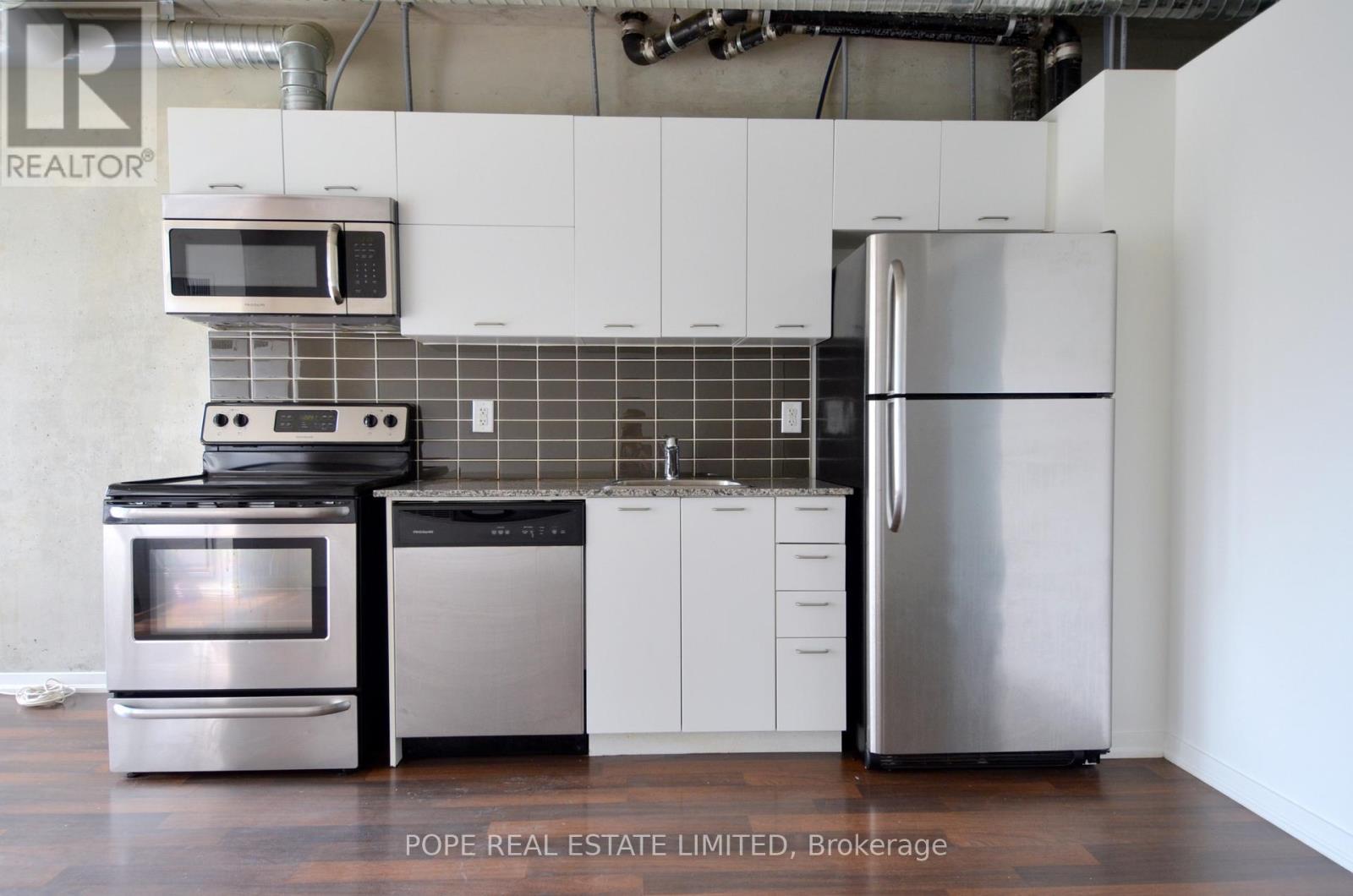 Kitchen 1 - 312 - 38 Joe Shuster Way, Toronto, ON - Indoor Photo Showing Kitchen With Stainless Steel Kitchen