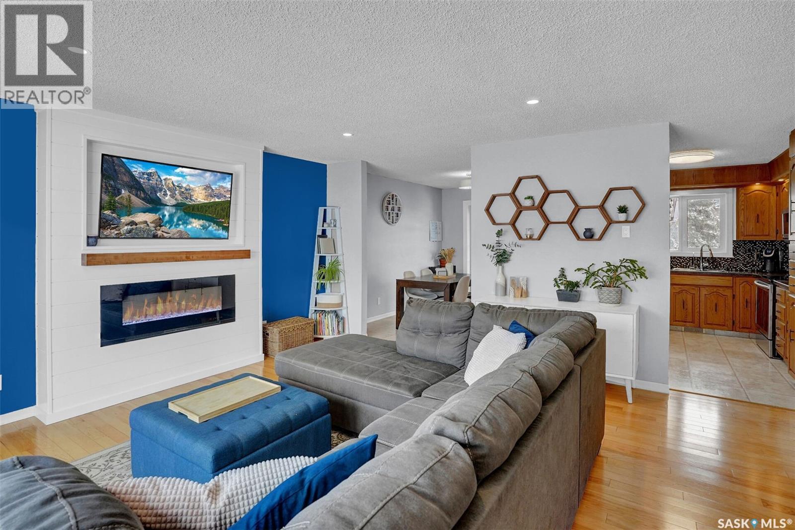 1245 Runciman Crescent N, Regina, SK - Indoor Photo Showing Living Room With Fireplace