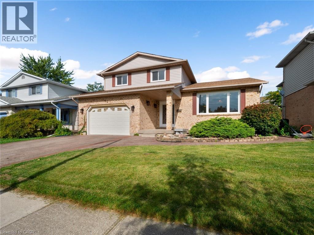 View of front facade with driveway, brick siding, an attached garage, and a front yard - 24 Keefer Road, Thorold, ON - Outdoor With Deck Patio Veranda With Facade