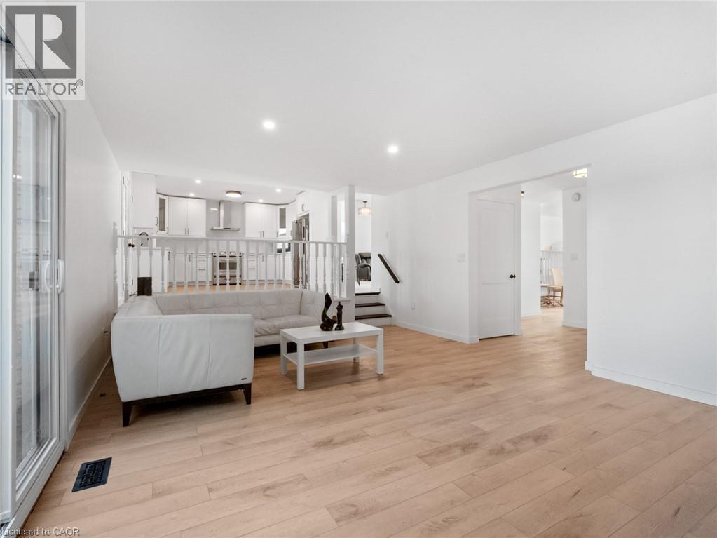 Living room with recessed lighting, visible vents, stairway, and light wood finished floors - 24 Keefer Road, Thorold, ON - Indoor