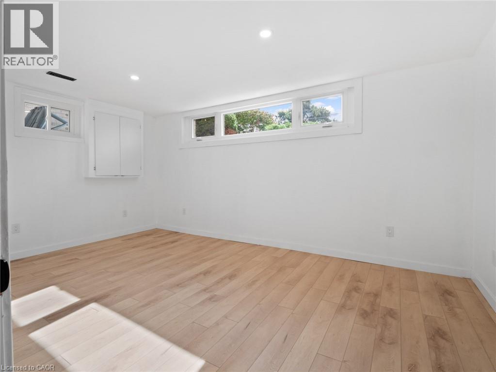 Unfurnished room featuring light wood-style flooring, baseboards, and recessed lighting - 24 Keefer Road, Thorold, ON - Indoor Photo Showing Other Room