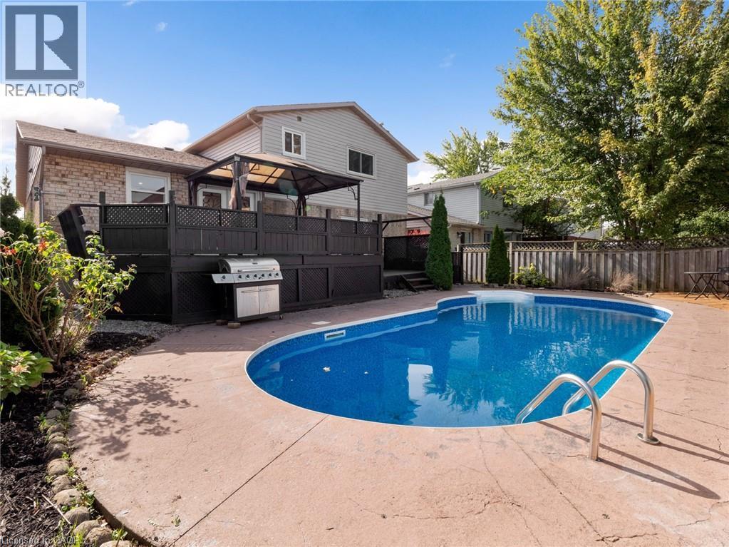 View of pool with a patio, fence, a fenced in pool, and grilling area - 24 Keefer Road, Thorold, ON - Outdoor With In Ground Pool With Deck Patio Veranda