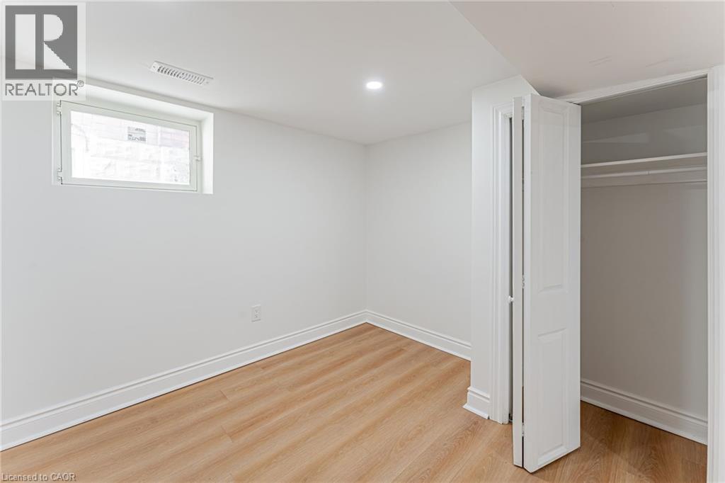 Bright bedroom with closet & large window - 15 Barnesdale Avenue N, Hamilton, ON - Indoor Photo Showing Other Room